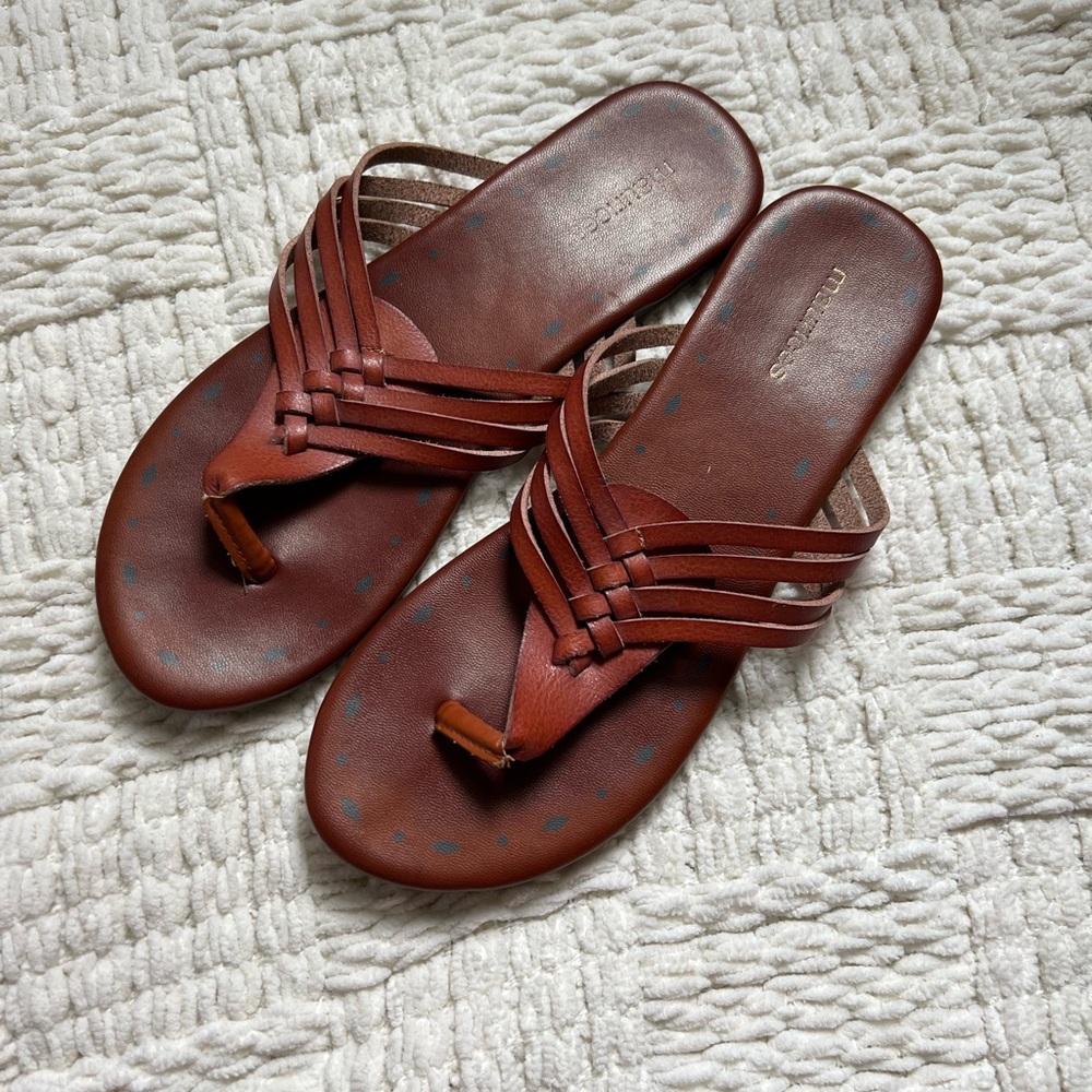 woman’s tan backless sandals